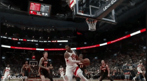 A Basketball Game Is Being Played In Front Of A Scoreboard Sponsored By Uber GIF