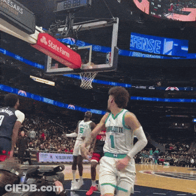 A Basketball Game Is Being Played In Front Of A Scoreboard That Says State Farm GIF