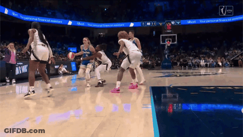 A Basketball Game Is Being Played In Front Of A Scoreboard That Says " Your Personal Financial Assistant " GIF