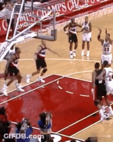 A Basketball Game Is Being Played In Front Of A Sign That Says Champions GIF