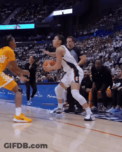 A Basketball Game Is Being Played In Front Of A Sign That Says ' Disney ' On It GIF