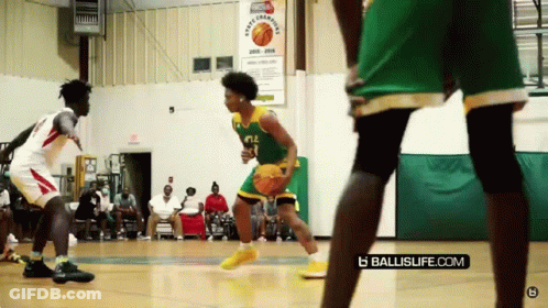 A Basketball Game Is Being Played In Front Of A Sign That Says Sports League GIF
