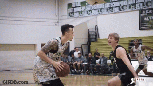 A Basketball Game Is Being Played In Front Of A Sign That Says ' State Champions ' GIF