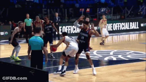 A Basketball Game Is Being Played In Front Of A Sign That Says " The Official Ball " GIF