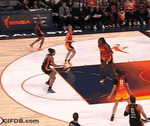 A Basketball Game Is Being Played In Front Of A Sign That Says Winba On It GIF