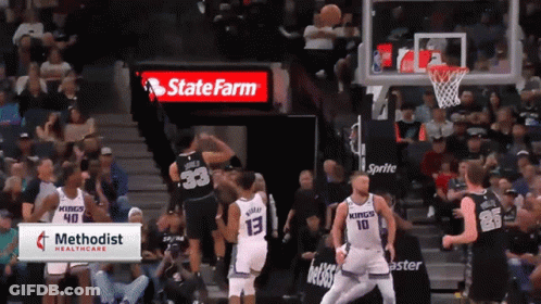 A Basketball Game Is Being Played In Front Of A State Farm Ad GIF