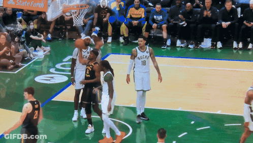 A Basketball Game Is Being Played In Front Of A Statefarm Banner GIF