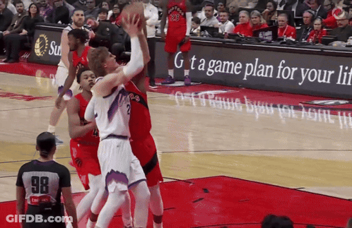 A Basketball Game Is Being Played In Front Of An Advertisement For A Game Plan For Your Life GIF