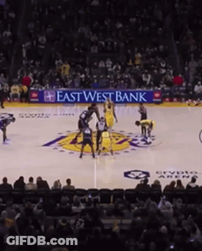 A Basketball Game Is Being Played In Front Of An East West Bank Ad GIF