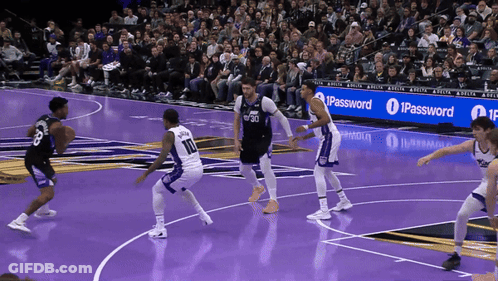 A Basketball Game Is Being Played In Front Of An Ipassword Banner GIF
