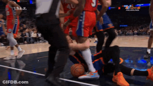 A Basketball Game Is Being Played In Philadelphia And A Player Is Laying On The Floor GIF