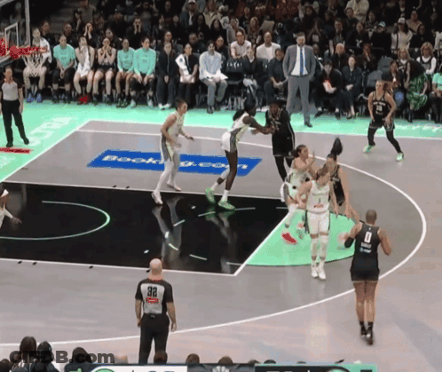 A Basketball Game Is Being Played On A Court That Has A Booking.com Advertisement On It GIF