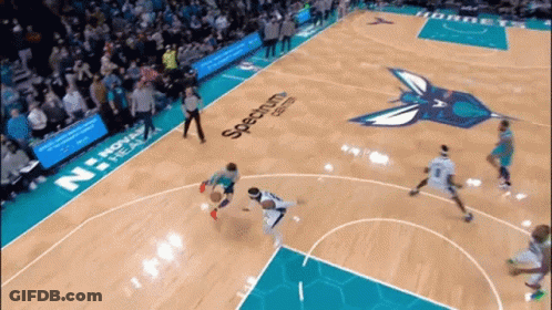 A Basketball Game Is Being Played On A Court That Has Spectrum Written On The Floor GIF