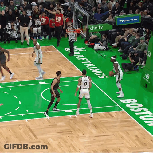 A Basketball Game Is Being Played On A Court That Has The Word Boston Written On It GIF