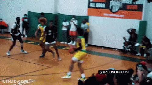 A Basketball Game Is Being Played On A Court With A Banner That Says Ballislife.com . GIF