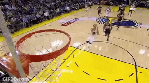 A Basketball Game Is Being Played On A Court With A Crowd In The Stands Watching . GIF