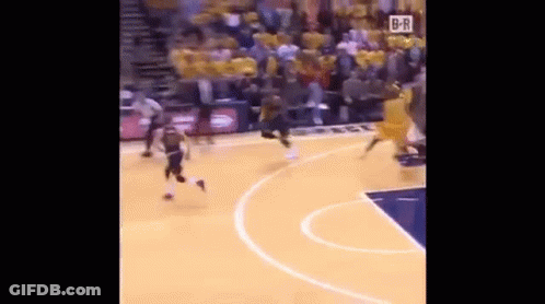A Basketball Game Is Being Played On A Court With A Crowd In The Stands Watching . GIF