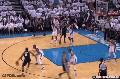 A Basketball Game Is Being Played On A Court With A Crowd In The Stands Watching . GIF