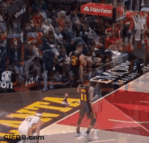 A Basketball Game Is Being Played On A Court With A Crowd In The Stands . GIF