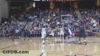 A Basketball Game Is Being Played On A Court With A Crowd Watching GIF
