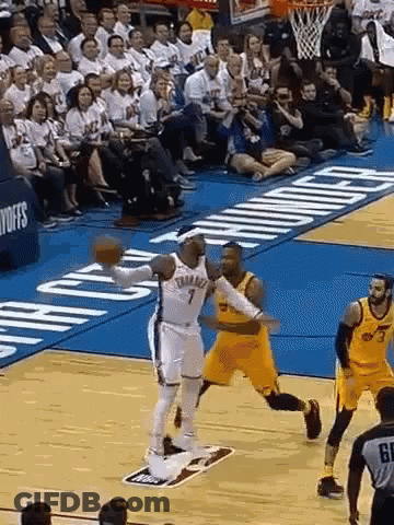 A Basketball Game Is Being Played On A Court With A Crowd Watching . GIF
