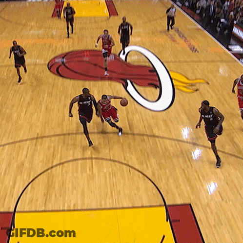 A Basketball Game Is Being Played On A Court With A Logo For The Heat On It GIF
