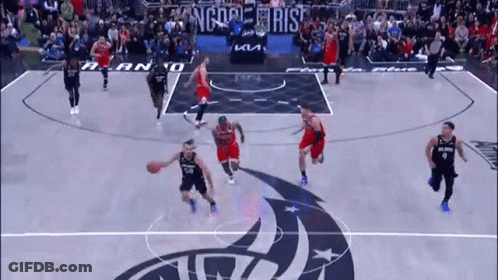 A Basketball Game Is Being Played On A Court With A Logo That Says Kings On It . GIF