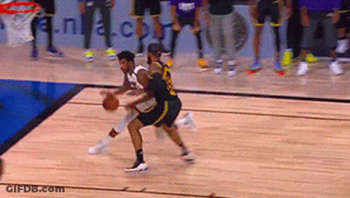 A Basketball Game Is Being Played On A Court With A Nba.com Banner In The Background GIF