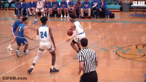 A Basketball Game Is Being Played On A Court With A Referee GIF