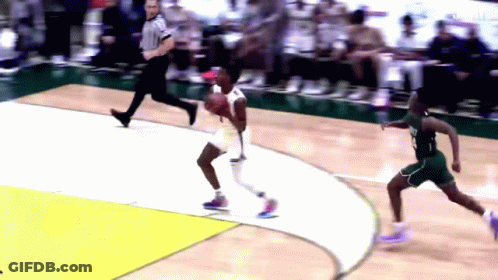 A Basketball Game Is Being Played On A Court With A Referee Watching GIF