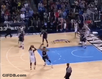 A Basketball Game Is Being Played On A Court With A Referee . GIF