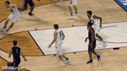A Basketball Game Is Being Played On A Court With A Referee GIF