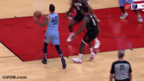 A Basketball Game Is Being Played On A Court With A Referee . GIF