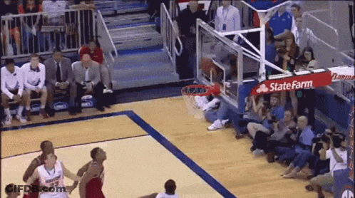 A Basketball Game Is Being Played On A Court With A Sign That Says State Farm On It GIF