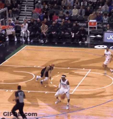 A Basketball Game Is Being Played On A Court With A Sign That Says Verizon On It GIF