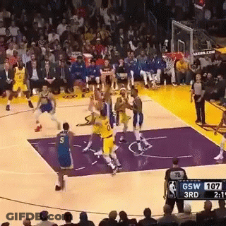 A Basketball Game Is Being Played On A Purple Court . GIF