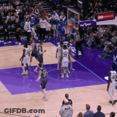 A Basketball Game Is Being Played On A Purple Court With A Crowd In The Stands GIF
