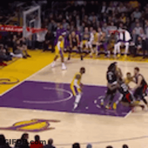 A Basketball Game Is Being Played On A Purple Court With A Crowd Watching . GIF