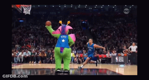 A Basketball Game Is Being Played With A Mascot Wearing A Purple And Blue Outfit With A Star On The Back GIF