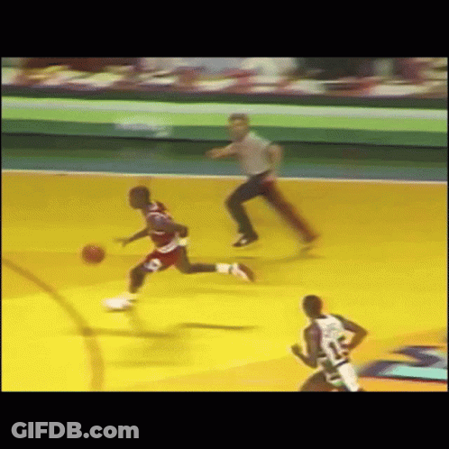 A Basketball Game Is Being Played With A Referee Watching GIF