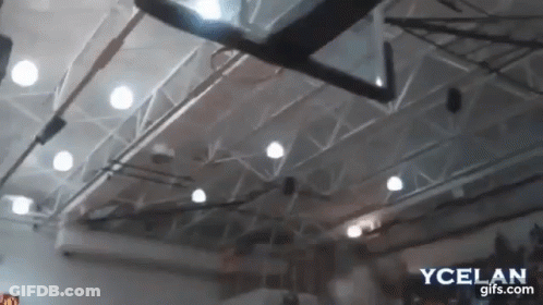 A Basketball Hoop Is Hanging From The Ceiling Of A Gymnasium GIF