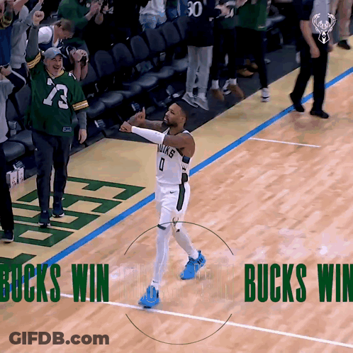 A Basketball Player Celebrates On The Court With The Words Bucks Win Behind Him GIF