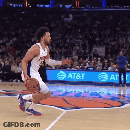 A Basketball Player Dribbles A Basketball On A Court With An At & T Ad In The Background GIF