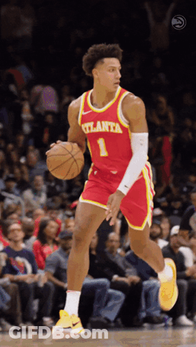 A Basketball Player For The Atlanta Team Is Dribbling The Ball GIF