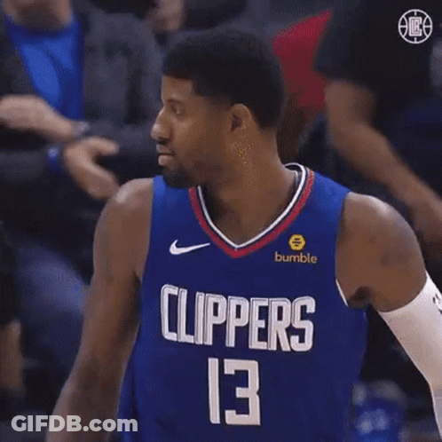 A Basketball Player For The Clippers Is Standing In Front Of A Crowd . GIF