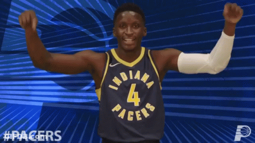 A Basketball Player For The Indiana Pacers Celebrates With His Fist In The Air GIF