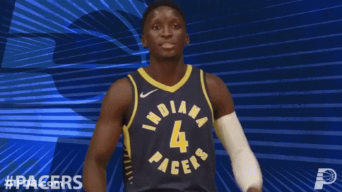 A Basketball Player For The Indiana Pacers Flexes His Arms GIF