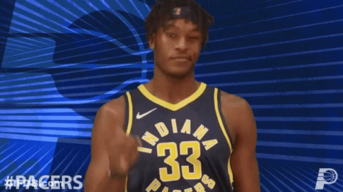 A Basketball Player For The Indiana Pacers Points Upwards GIF