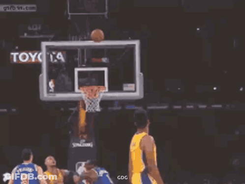 A Basketball Player For The Lakers Is Jumping In The Air With His Arms Outstretched While Holding A Basketball . GIF