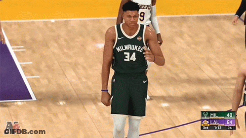 A Basketball Player For The Milwaukee Bucks Is Walking On The Court GIF
